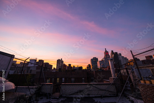 NEW YORK, NEW YORK USA – OCTOBER 22, 2022: Sky glows over the East Village cityscape during twilight in New York City. 