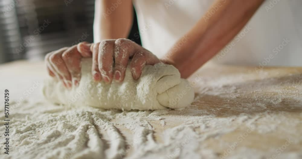 Animation of hand of asian female baker preparing sourdough for bread