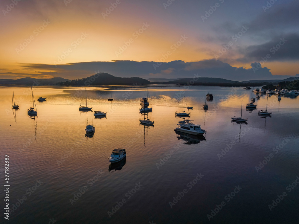 Fototapeta premium Soft and hazy aerial sunrise waterscape with boats