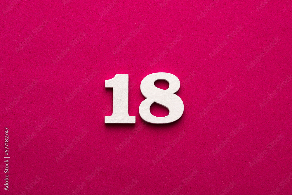 Number 18 - white number in wood on rhodamine red background Number 18 - white number in wood on rhodamine red background