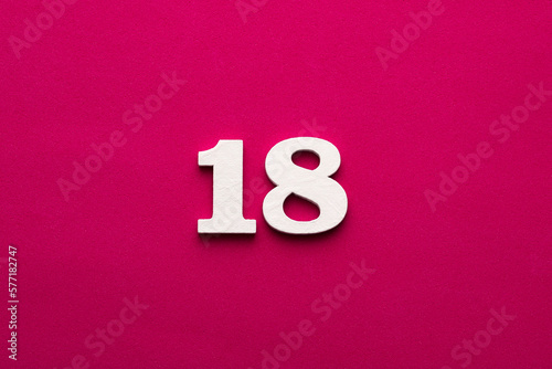 Number 18 - white number in wood on rhodamine red background