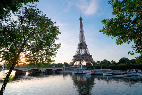 Paris Eiffel Tower and river Seine with sunrise in Paris, France. Eiffel Tower is one of the most iconic landmarks of Paris.