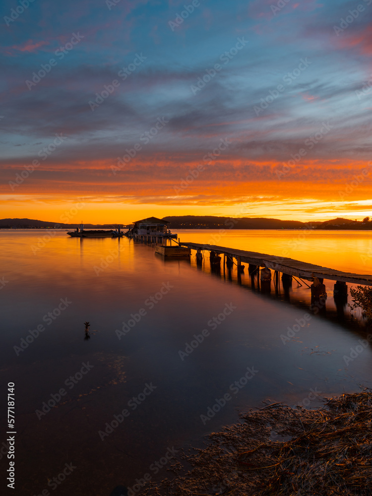 Beautiful view of jetty in the lake at sunrise time.