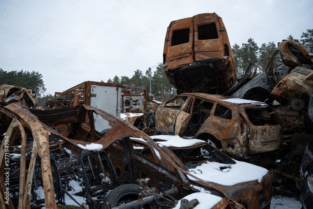 Fototapeta premium Stacked a bunch of crashed cars after fire and missiles attacks in town