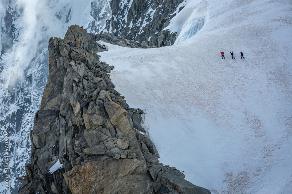 Mountaineers walking on ice in Mont Blanc, hikers and alpine glacier , Chamonix