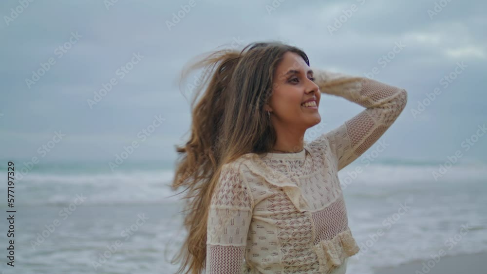 Gorgeous model posing ocean nature closeup. Serious lady touching hair walking Gorgeous model posing ocean nature closeup. Serious lady touching hair walking