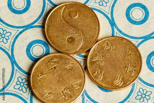 I ching ancient Chinese oracle, Book of Changes or Classic of Changes, with old coins photo