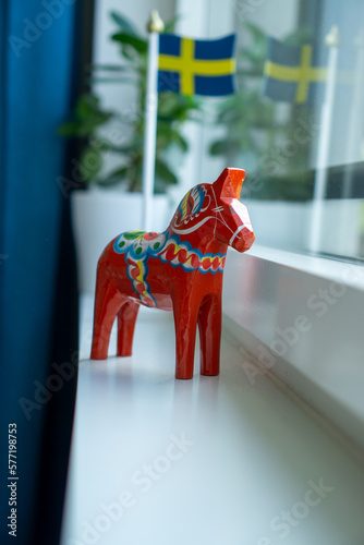 Dalecarlian Horse, (Dalahäst) . Traditional Swedish Symbol of Dalarna, Sweden. Red hand painted wooden statue of a horse. photo