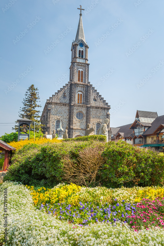 Stone Church with colorful flowerbed, Gramado village, Southern Brazil