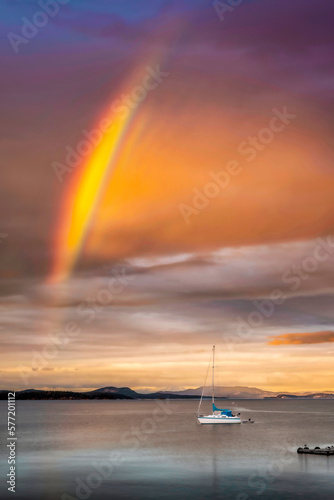 Rainbow over sea and boat © Kelly