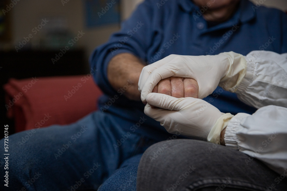 Close-up of a doctor's hands holding the hands of an elderly patient Close-up of a doctor's hands holding the hands of an elderly patient