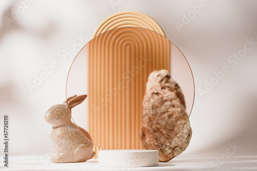 Photography Beige easter pedestal or podium product presentation display with ceramic rabbit bunny and rock