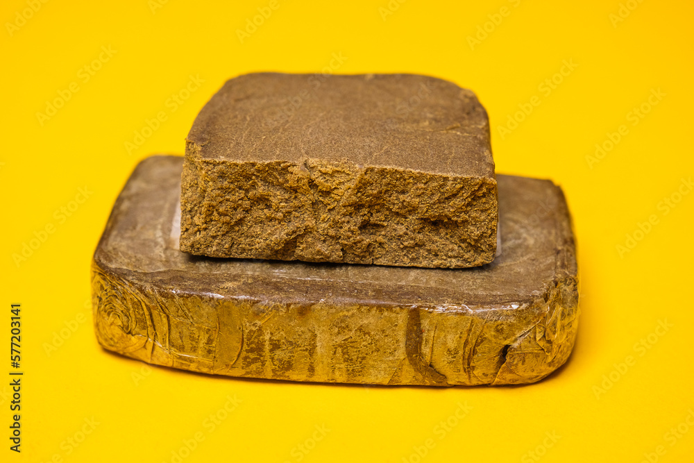 Gelato OG Autodry hash. Medical marijuana extraction super dry hashish high quality cannabis pollen on a yellow background. Gelato OG Autodry hash. Medical marijuana extraction super dry hashish high quality cannabis pollen on a yellow background.