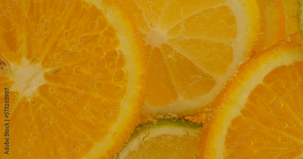 Ripe citrus lemonade, orange, lemon, lime slices in air bubbles. Ripe citrus lemonade, orange, lemon, lime slices in air bubbles.
