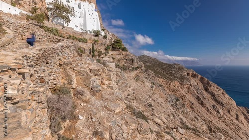 Panorama showing the famous white Hozoviotissa Monastery standing on a rock over the Aegean sea in Amorgos island timelapse hyperlapse, Cyclades, Greece. photo