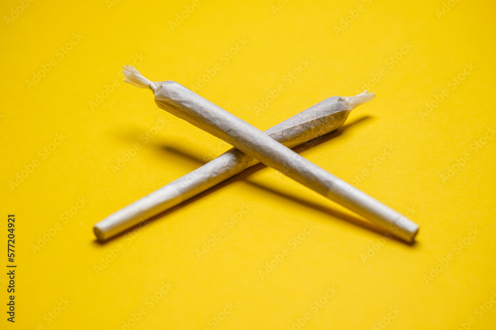 Medical Cannabis Hashish Marijuana rolled Joints isolated on a yellow background. Cool flat lay, copy space Medical Cannabis Hashish Marijuana rolled Joints isolated on a yellow background. Cool flat lay, copy space