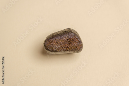 A piece of high quality hashish isolated on a white background. Medical marijuana extraction hash cannabis pollen hashish