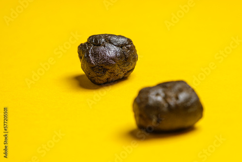 Pieces of high quality Pakistani hashish isolated on a yellow background. Medical marijuana extraction hash cannabis pollen hashish