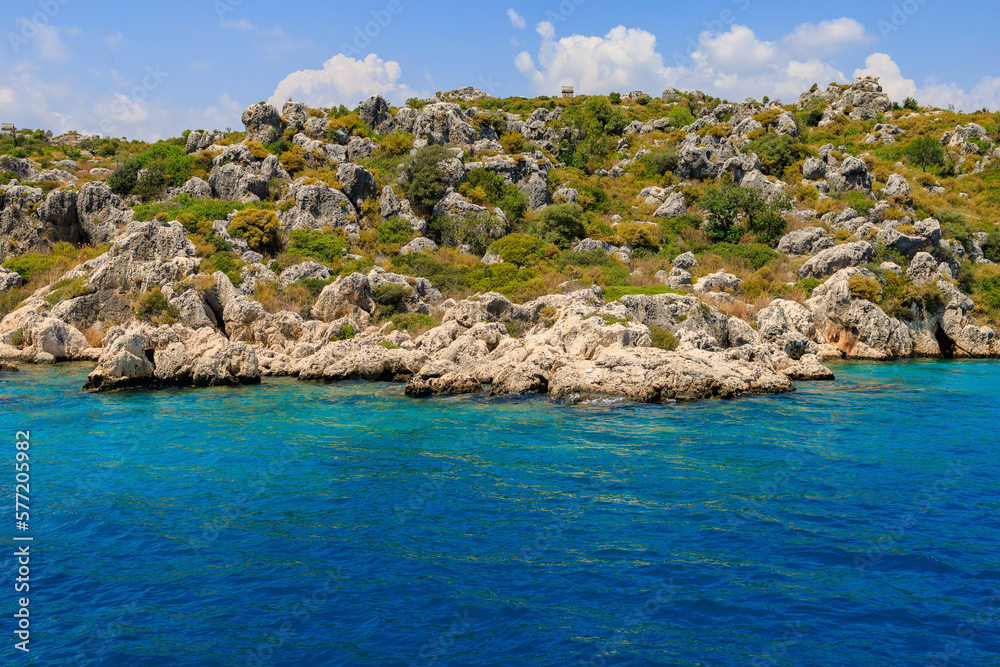View of the rocky shore from the sea. Mediterranean Sea in Turkey. Popular tourist places. Background View of the rocky shore from the sea. Mediterranean Sea in Turkey. Popular tourist places. Background