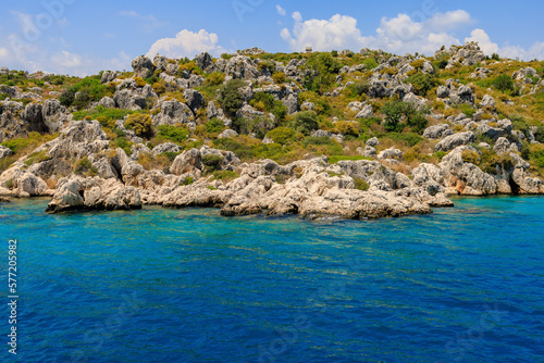 View of the rocky shore from the sea. Mediterranean Sea in Turkey. Popular tourist places. Background