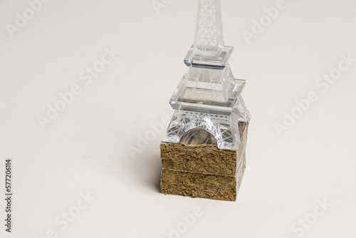 A figurine of the Eiffel Tower on hashish stick ready for sale on a white background. France Paris droug dealing concept. photo