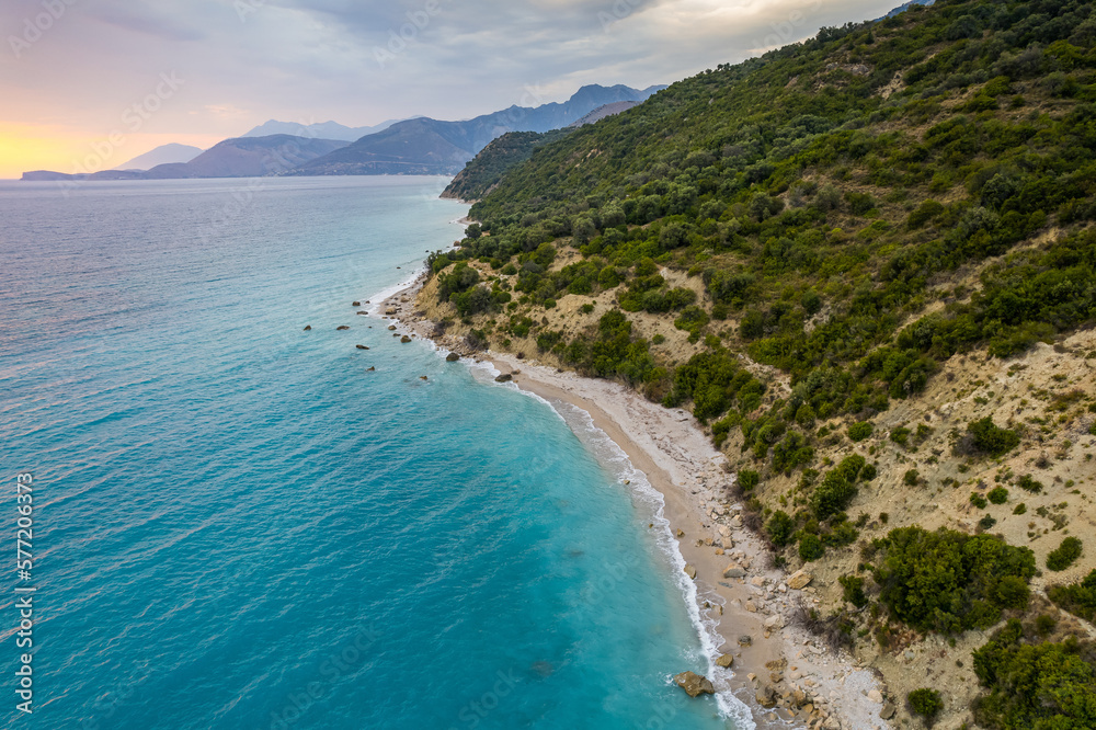 Aerial view of green shore with huge rocks by Bunec Beach area in Summer 2022, Albania