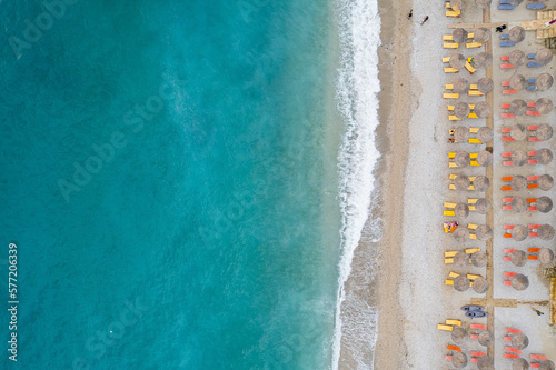 Straight down view on parasols and beach by Bunec Beach area in Summer 2022, Albania