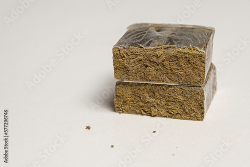 Hashish stick ready for sale on a white background. Medical marijuana extraction zkittlez dry hash cannabis pollen.