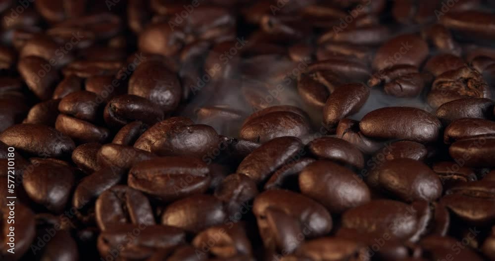 Close up of seeds of coffee. Fragrant coffee beans are roasted smoke comes from coffee beans. Close up of seeds of coffee. Fragrant coffee beans are roasted smoke comes from coffee beans.