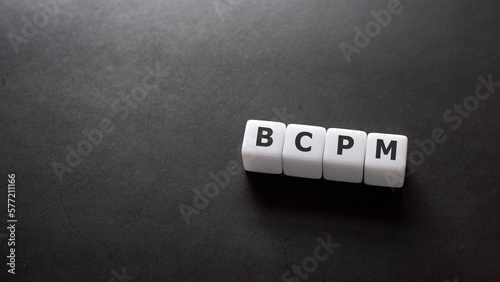 There is white cubes with the word BCPM. It is an acronym for Business Continuity Plan Management an eye-catching image. photo