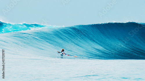 Surfer paddles to line up among the huge waves © Dudarev Mikhail
