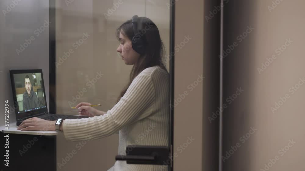 the girl participates in a business meeting in the meeting room, makes notes, talks with the teacher the girl participates in a business meeting in the meeting room, makes notes, talks with the teacher