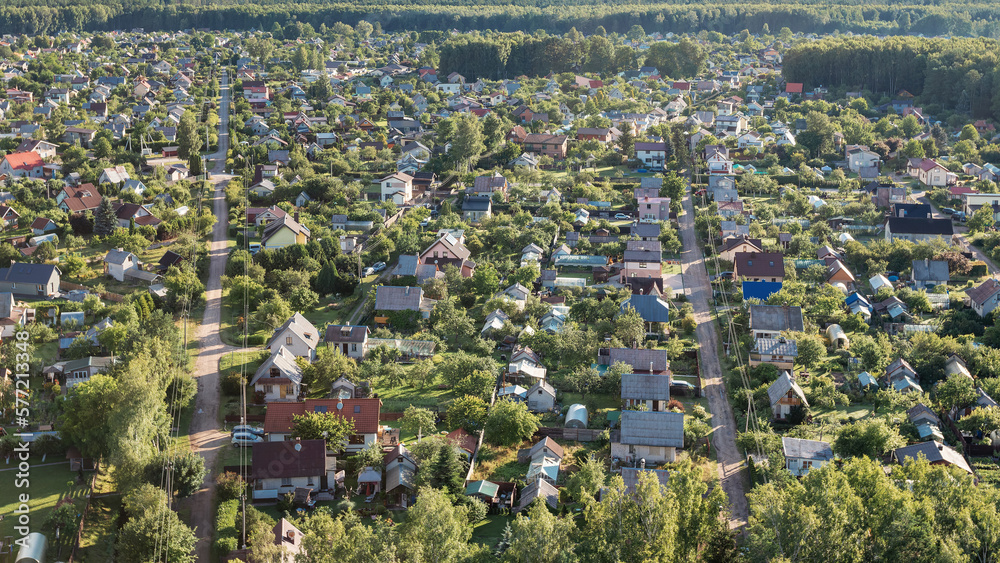 Aerial view of housing estate, Summer morning, village surrounded by forest, hot air balloon flight