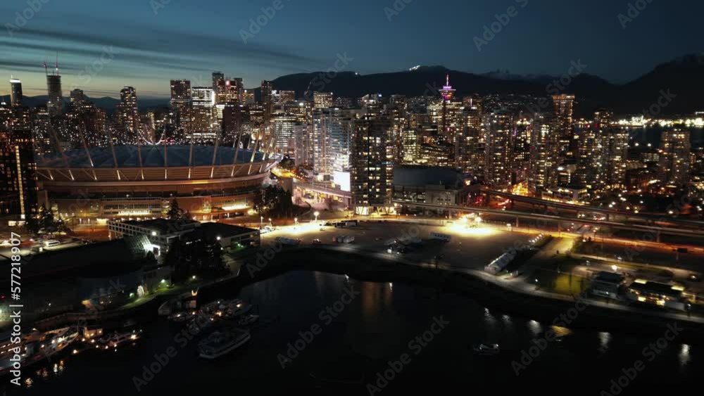 Aerial hyperlapse of night cityline with skyscrapers. Vancouver, Canada.