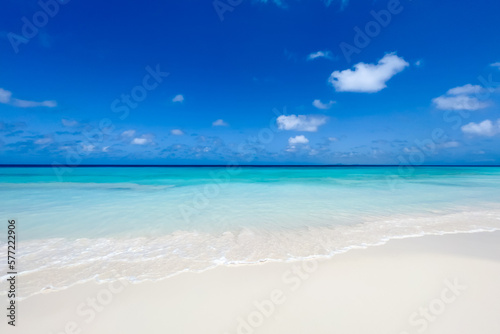 White sand beach with turquoise water and blue sky