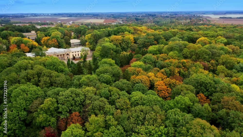 Historical palace in the beautiful green park. Cityscape and agricultural fields at backdrop. Aerial view. Historical palace in the beautiful green park. Cityscape and agricultural fields at backdrop. Aerial view.
