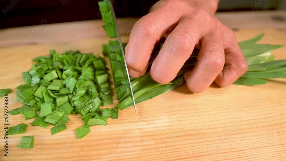 Cutting spring onions in slowmotion close up. Cutting spring onions in slowmotion close up.
