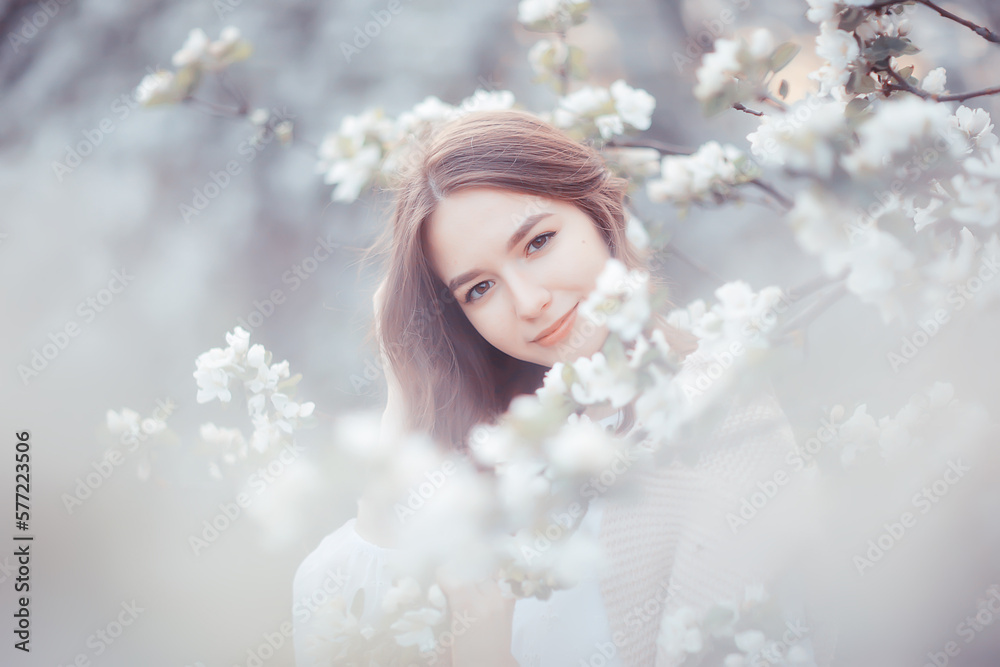 springtime fashion portrait of a young girl in a blooming cherry garden, tenderness of the morning springtime fashion portrait of a young girl in a blooming cherry garden, tenderness of the morning