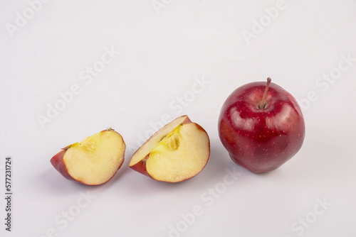 Falling red apple slice isolated on white background.