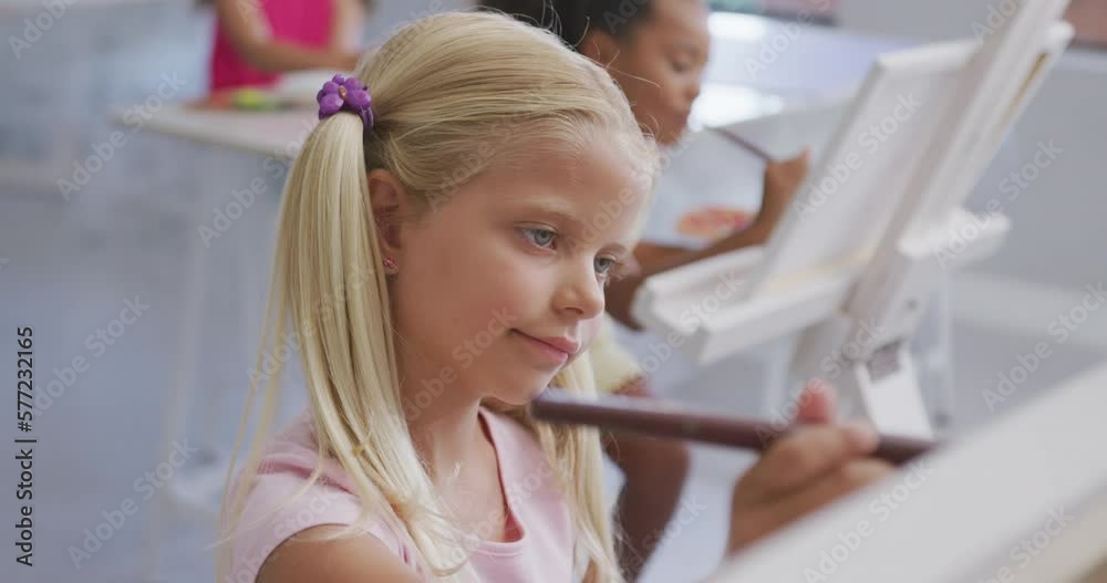 Video of focused caucasian girl painting during art lessons at school Video of focused caucasian girl painting during art lessons at school