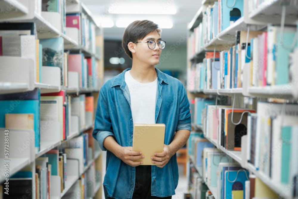 Student reading book at library. Student reading book at library.