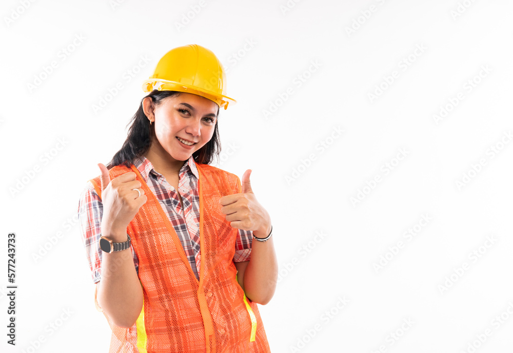 a beautiful architect in savety waistcoat standing with thumbs up on isolated background