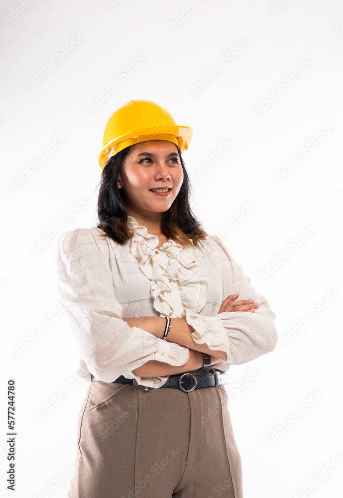a female architect standing with handcrossed and looking up on isolated background a female architect standing with handcrossed and looking up on isolated background