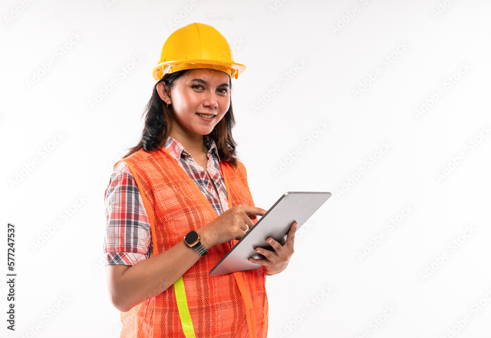 a female architect in savety waistcoat using the digital tablet on isolated background a female architect in savety waistcoat using the digital tablet on isolated background