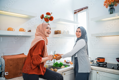 muslim woman friend preparing some food for dinner in the kitchen photo