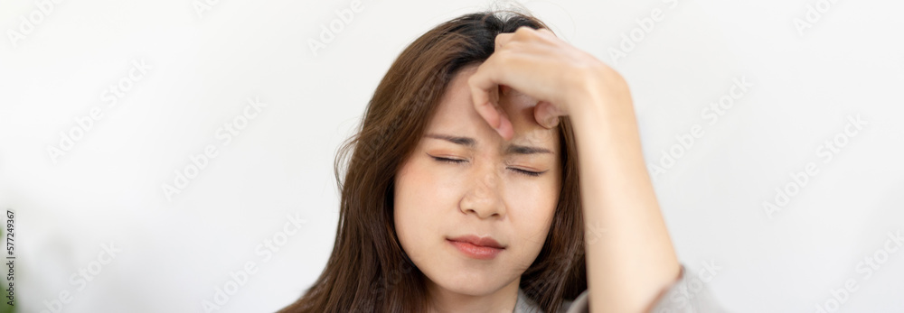 Stressed woman holding her temples with severe problems in her life, Family problems, Pressure from work, Poor financial, Despair in life, discouraged and deeply saddened, Panic attacks. Stressed woman holding her temples with severe problems in her life, Family problems, Pressure from work, Poor financial, Despair in life, discouraged and deeply saddened, Panic attacks.