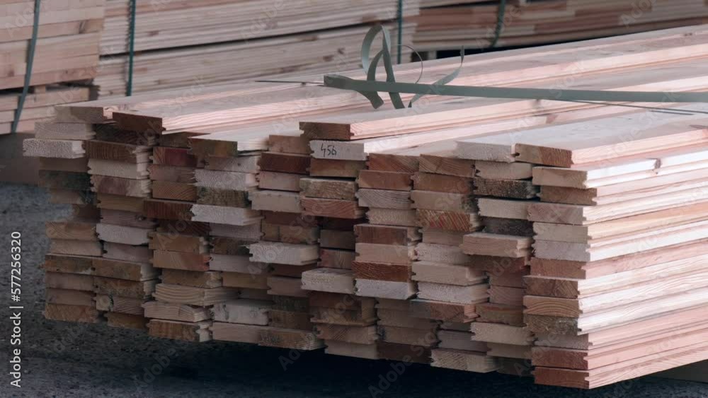 Piles of wooden boards in sawmill. Stock pine wood log in furniture factory. Warehouse for sawing boards for sale, inside a building. Wood timber stack of blanks construction material industry Piles of wooden boards in sawmill. Stock pine wood log in furniture factory. Warehouse for sawing boards for sale, inside a building. Wood timber stack of blanks construction material industry
