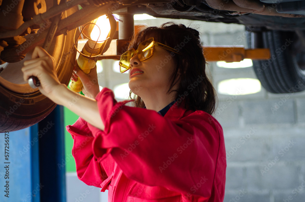 Asian woman auto mechanic work in vehicle repair shop showing thumb up, international Women's day Asian woman auto mechanic work in vehicle repair shop showing thumb up, international Women's day