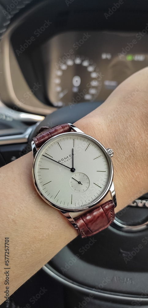 Foto Stock BANGKOK, THAILAND - MARCH 4 : Nomos Orion model, blued steel  hands with brown alligator strap, Bauhaus classic clean design, wear on  wrist in Bangkok, Thailand, on March 4, 2023. | Adobe Stock