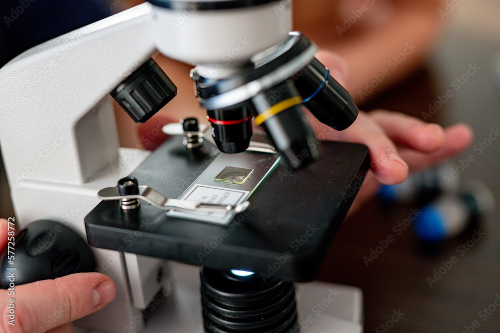 Microscope close-up. research under magnification. Amateur microscope for home study. scientific equipment Microscope close-up. research under magnification. Amateur microscope for home study. scientific equipment